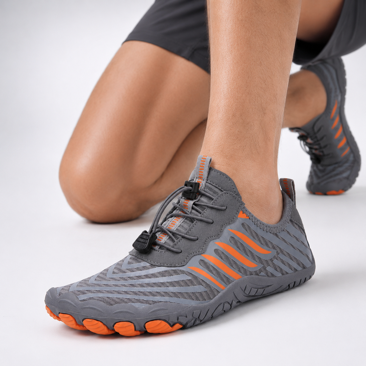 Barefoot gym shoes in Grey Orange on a training floor