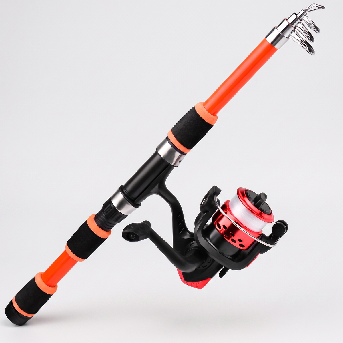Telescopic fishing rod and reel combo in orange, extended