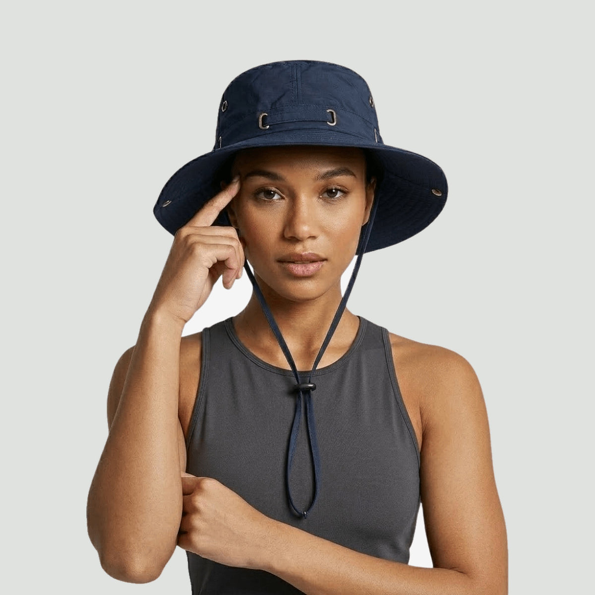 Woman wearing the lightweight boonie hat in Navy Blue with the chin strap done up