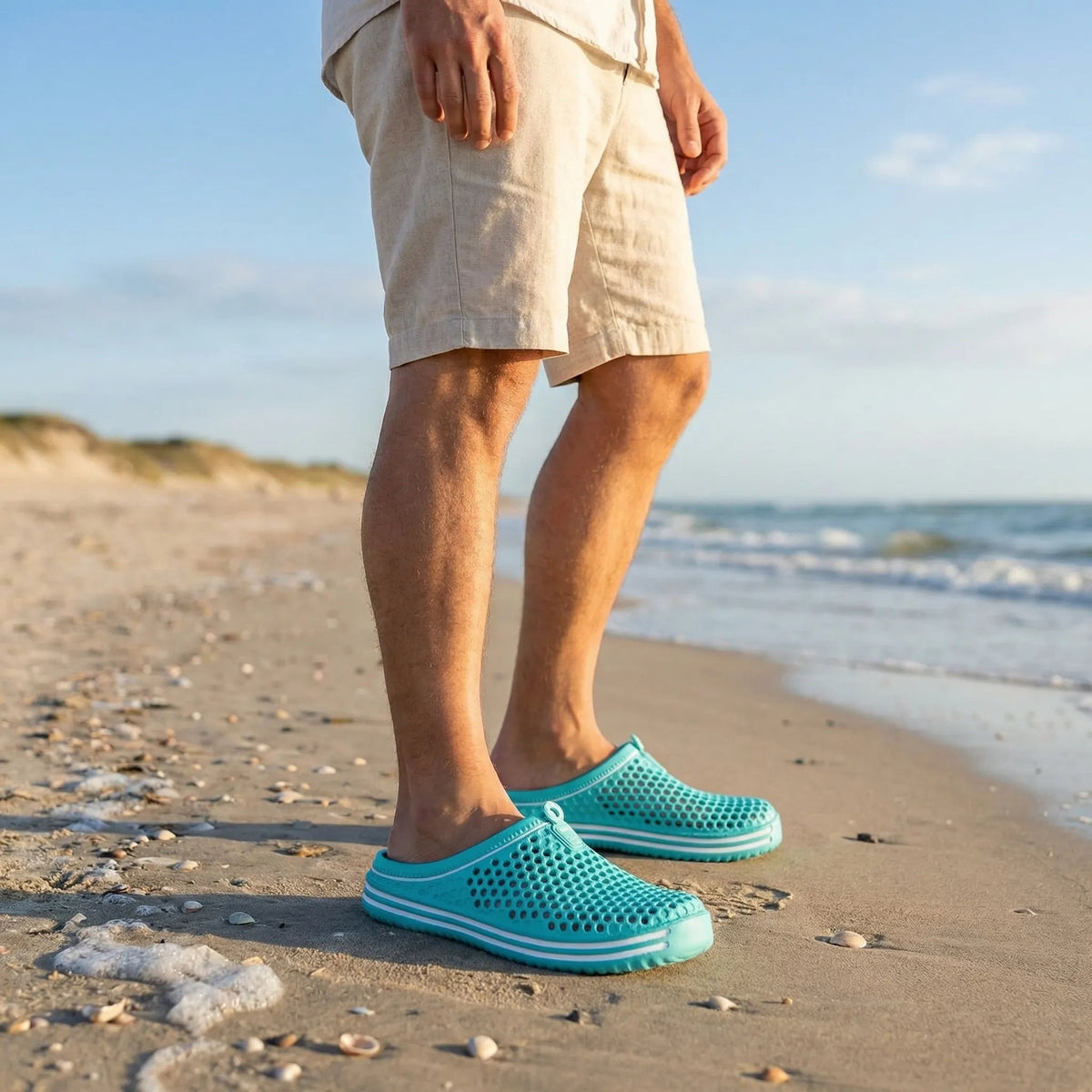 Man wearing the EVA clogs in Aqua on the beach