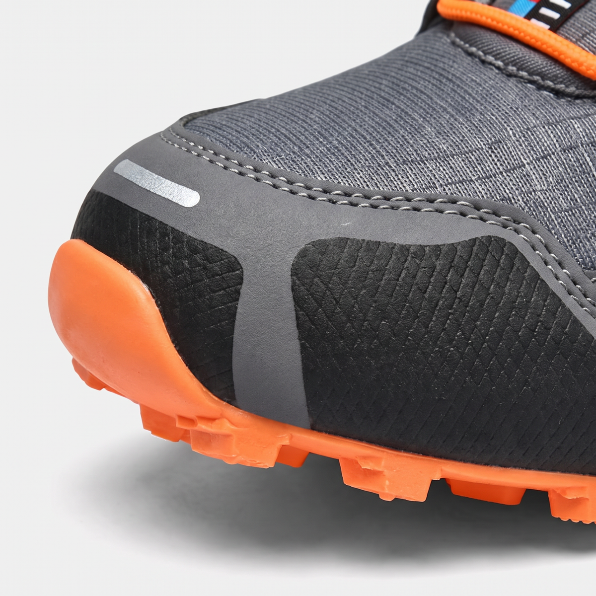 Reinforced rubber toe cap close-up on trail running shoes