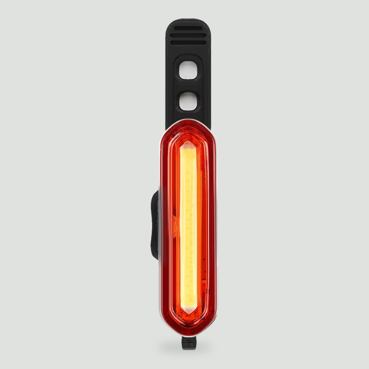 Rear bike light mounted upright with its strap