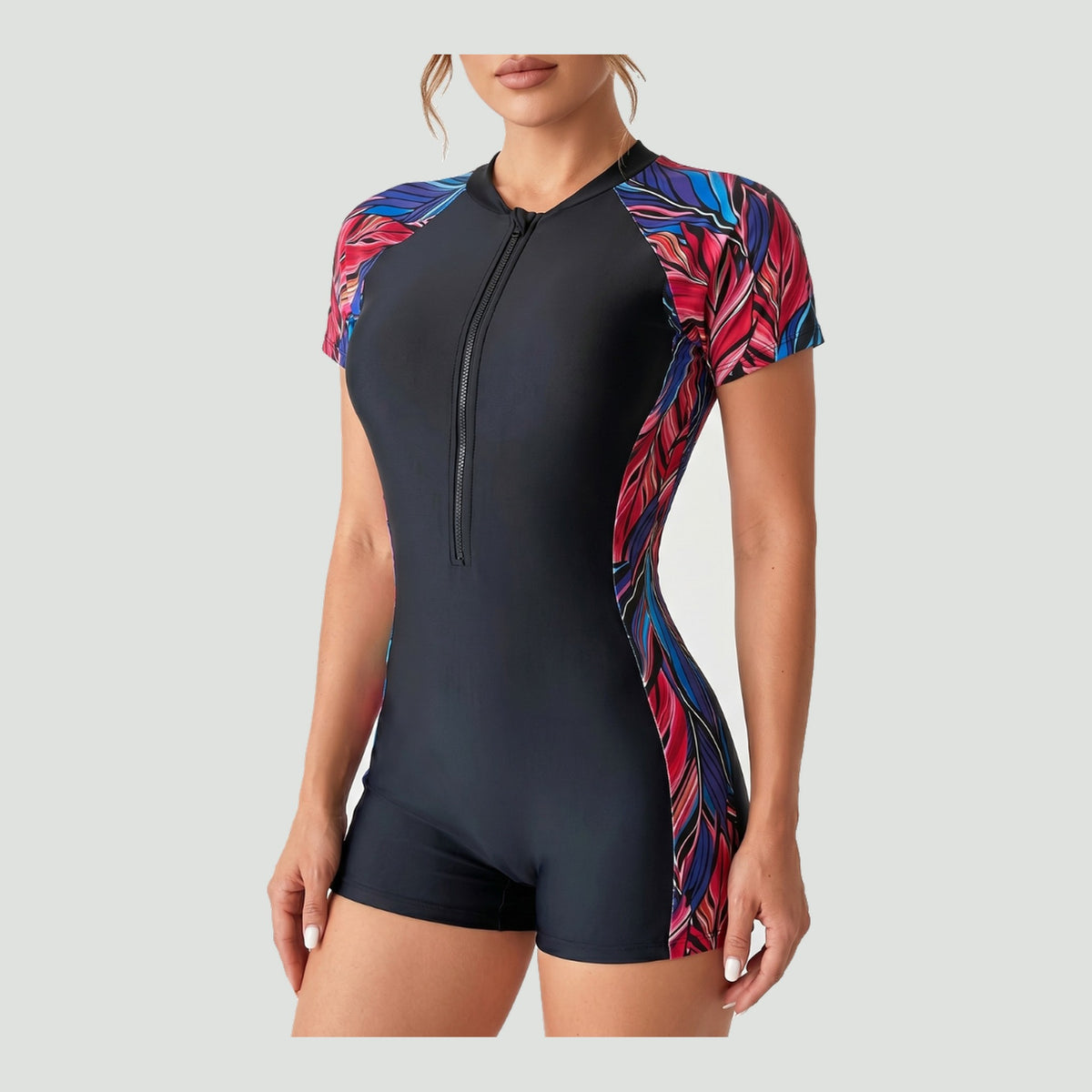 Women's one piece swimsuit in Red Tropical with short sleeves and front zip